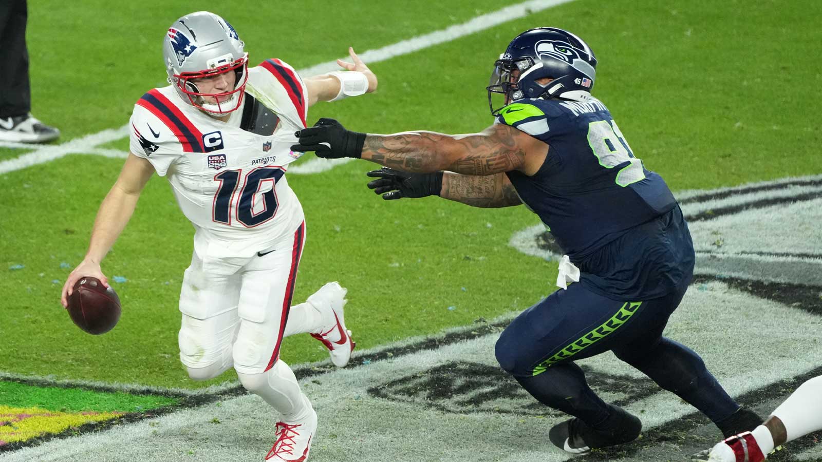 New England Patriots quarterback Drake Maye (10) is pressured by Seattle Seahawks defensive tackle Byron Murphy II (91) in the second half in Super Bowl LX at Levi's Stadium.