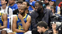 Golden State Warriors guard Chris Paul (left) and forward Draymond Green (right) sit on the team bench during the second half between the Dallas Mavericks and the Warriors at the American Airlines Center.