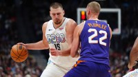 Phoenix Suns center Mason Plumlee (22) blocks Denver Nuggets center Nikola Jokic (15) in the second half at Ball Arena. Mandatory Credit: Ron Chenoy-Imagn Images