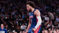 Pistons guard Cade Cunningham (2) reacts after a dunk during the second half against the New York Knicks at Madison Square Garden with Warriors' Draymond Green in the background