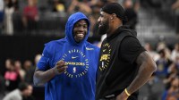 Golden State Warriors forward Draymond Green (23) and Los Angeles Lakers forward LeBron James (23) talk on court before warm up at T-Mobile Arena.