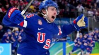 Quinn Hughes (43) of the United States celebrates his winning goal in overtime against Sweden in a men's ice hockey quarterfinal during the Milano Cortina 2026 Olympic Winter Games at Milano Santagiulia Ice Hockey Arena.