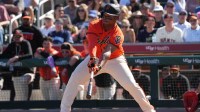 San Francisco Giants designated hitter Rafael Devers (16) hits against the Chicago Cubs in the third inning at Scottsdale Stadium.