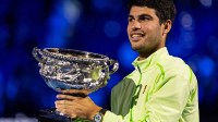 Carlos Alcaraz of Spain with the Norman Brookes Challenge Cup after his victory over Novak Djokovic of Serbia in the final of the menís singles at the Australian Open at Rod Laver Arena in Melbourne Park.