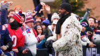 Former New England Patriots Randy Moss interacts with fans before the start of an AFC Divisional Round game against the Houston Texans at Gillette Stadium.
