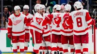 Members of the Detroit Red Wings celebrate defeating the Colorado Avalanche at Ball Arena.