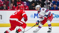 New York Rangers center Vincent Trocheck (16) brings the puck up ice as Shayne Gostisbehere (41) defends during the third period at Little Caesars Arena.
