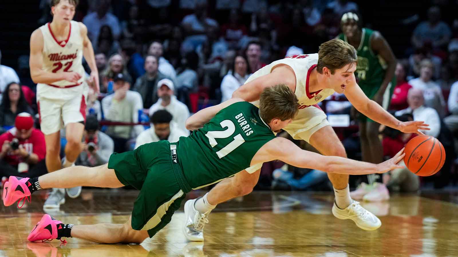 Ohio Bobcats guard Jesse Burris (21) battles for the loose ball against Miami (OH) RedHawks guard Peter Suder (5) in the first half at Millett Hall.
