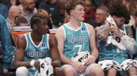 Charlotte Hornets forward Moussa Diabaté (14) and guard/forward Kon Knueppel (7) and guard LaMelo Ball (1) get a break during the second quarter against the Detroit Pistons at Spectrum Center.