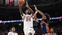 Arkansas Razorbacks wing Billy Richmond III (24) shoots over Auburn Tigers guard Elyjah Freeman (6) during the first half at Bud Walton Arena