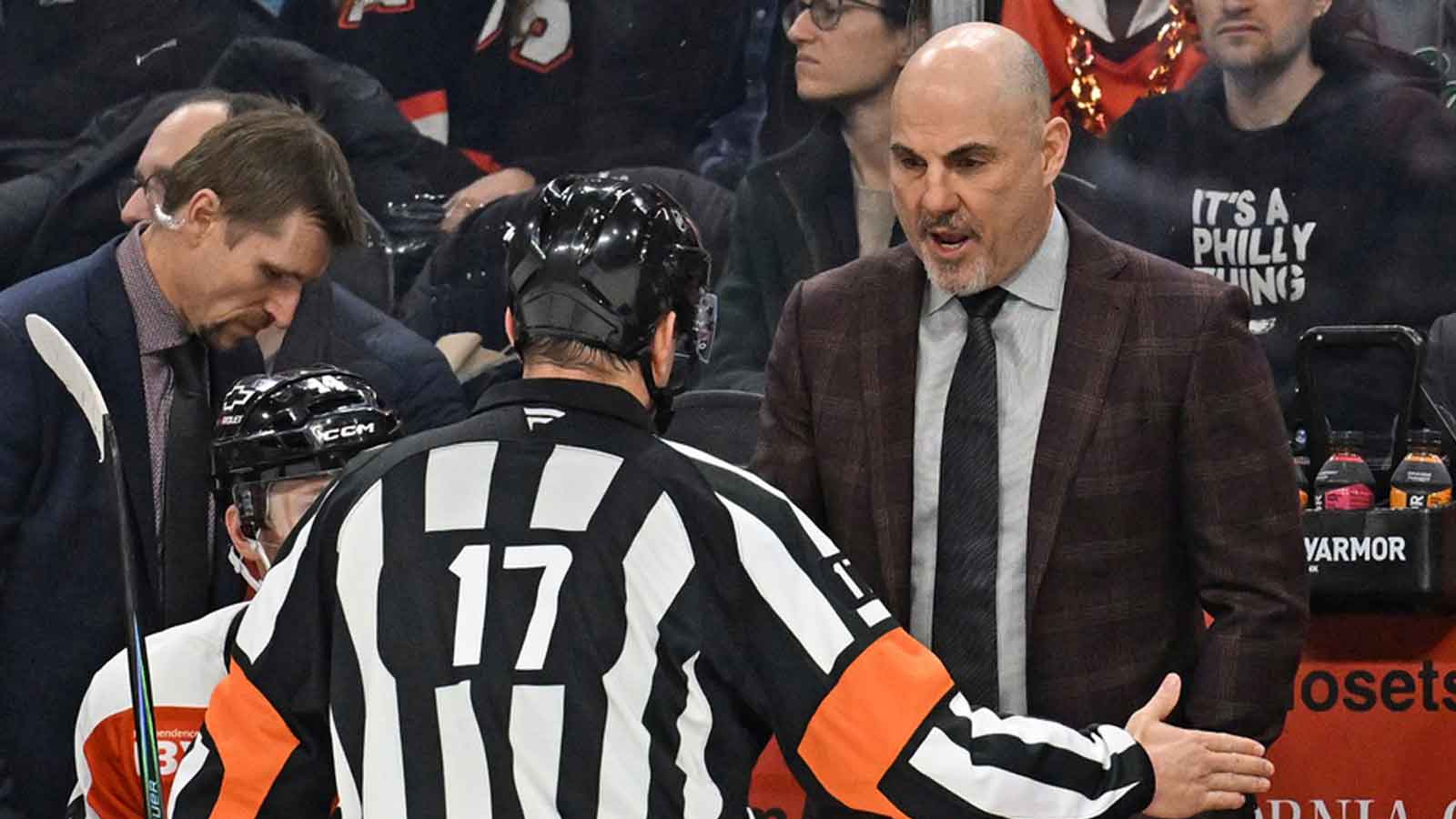 Philadelphia Flyers head coach Rick Tocchet speaks with referee Frederick L'Ecuyer (17) against the Anaheim Ducks during the third period at Xfinity Mobile Arena.