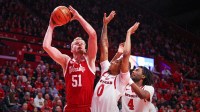 Nebraska Cornhuskers forward Rienk Mast (51) goes to the basket against Rutgers Scarlet Knights guard Tariq Francis (0) and forward Bryce Dortch (4) during the first half at Jersey Mike's Arena.