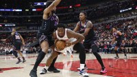 New York Knicks forward Og Anunoby (8) is defended by Chicago Bulls forward Guerschon Yabusele (28) and guard Rob Dillingham (7) during the first half at United Center.