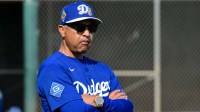 Los Angeles Dodgers manager Dave Roberts (30) looks on during a Spring Training workout at Camelback Ranch.