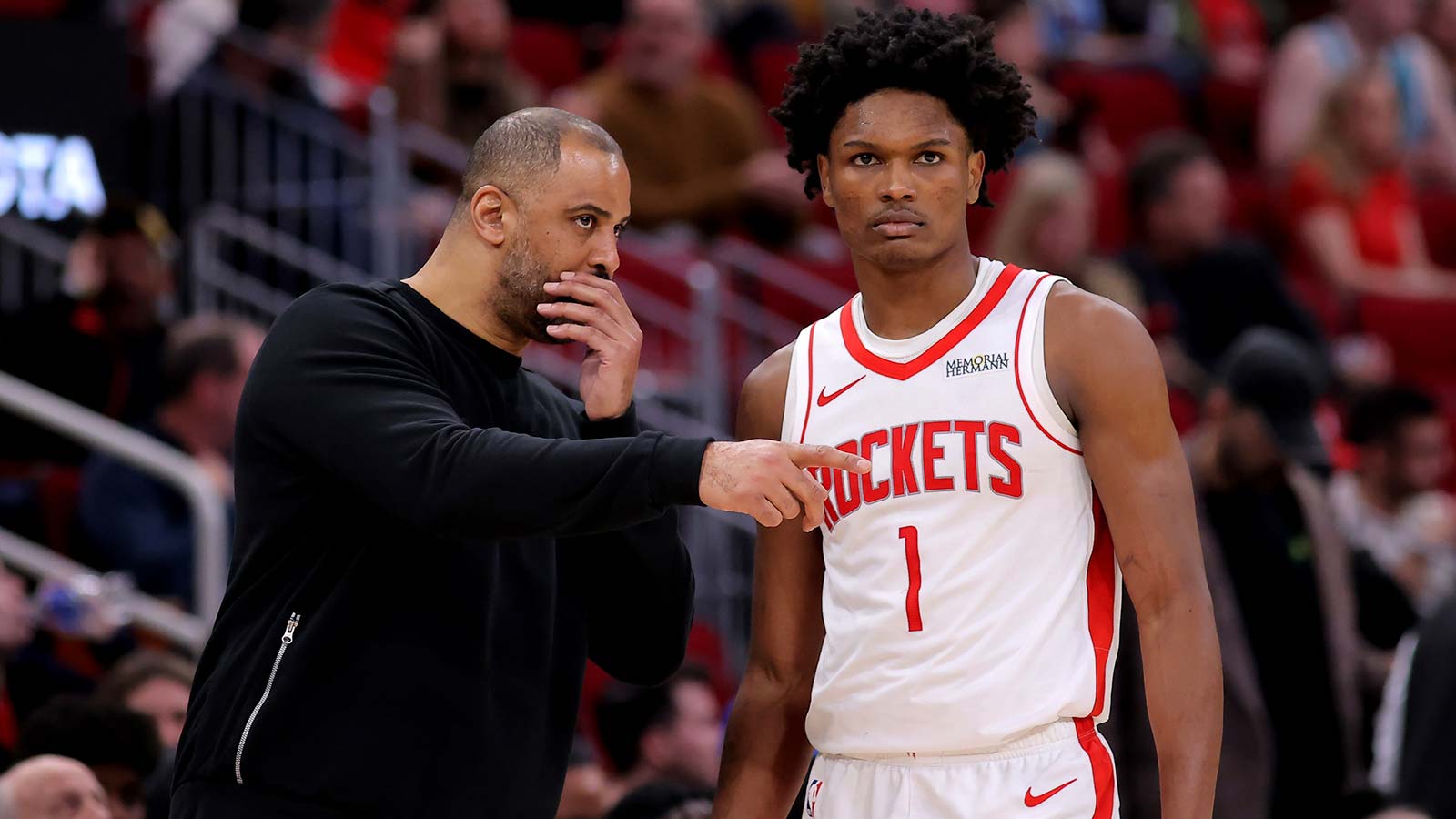 Rockets head coach Ime Udoka talks with Houston Rockets guard Amen Thompson (1) against the Charlotte Hornets during the third quarter at Toyota Center