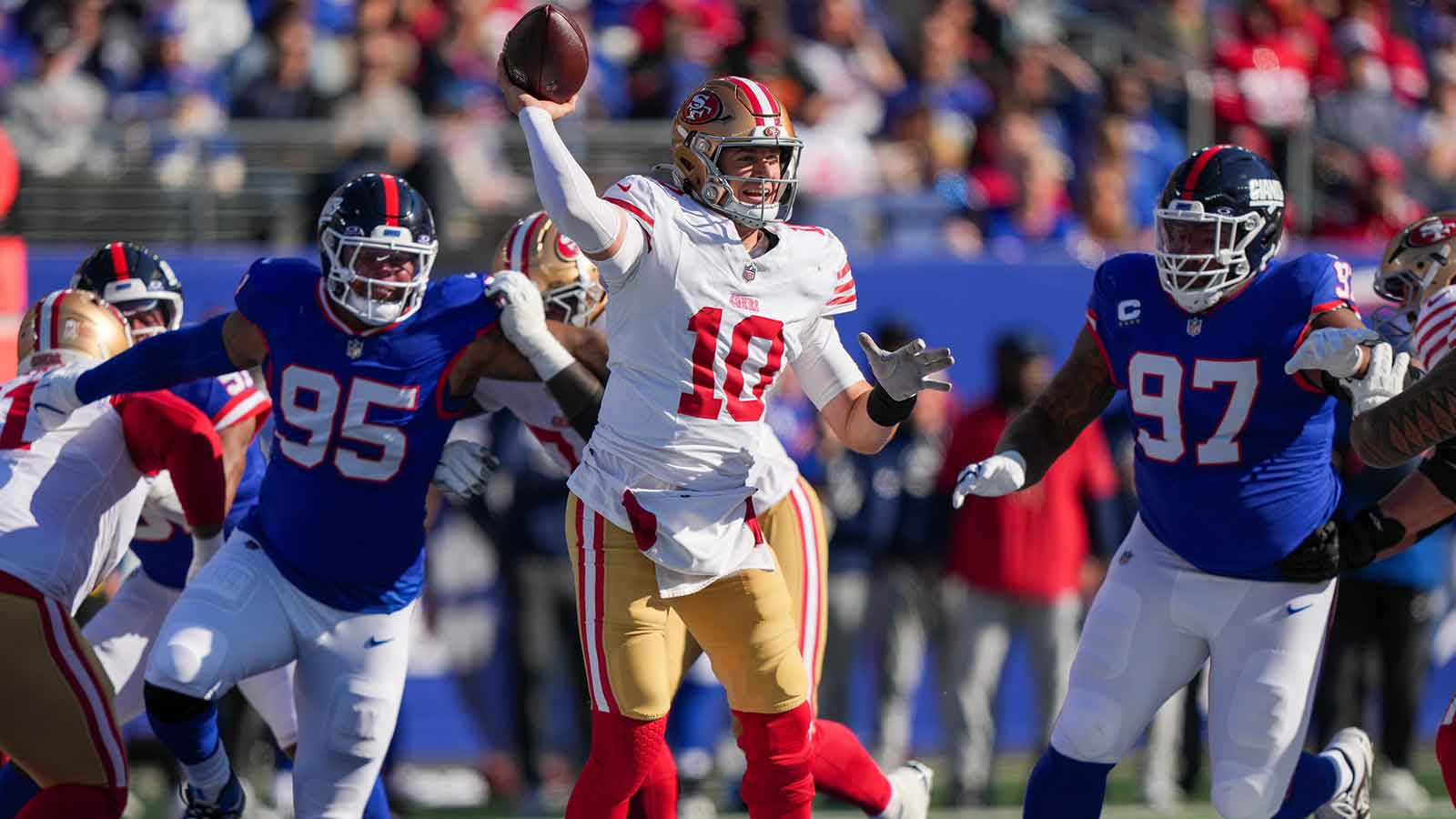 San Francisco 49ers quarterback Mac Jones (10) is pressured by New York Giants defensive tackle Roy Robertson-Harris (95) and defensive tackle Dexter Lawrence II (97) during the first half at MetLife Stadium. 