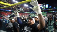 Seattle Seahawks defensive end Leonard Williams (99) celebrates with the Vince Lombardi trophy after defeating the New England Patriots in Super Bowl LX at Levi's Stadium.