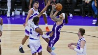 Sacramento Kings guard Devin Carter (22) takes a jump shot over Utah Jazz forward Cody Williams (5) during the second half at Delta Center.