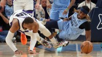 Sacramento Kings guard Russell Westbrook (18) and Memphis Grizzlies guard Jahmai Mashack (21) battle for a loose ball