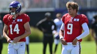 Minnesota Vikings quarterback J.J. McCarthy (9) and quarterback Sam Darnold (14) warm up during practice at Vikings training camp in Eagan, MN.