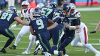 Seattle Seahawks quarterback Sam Darnold (14) hands off to Seattle Seahawks running back Kenneth Walker III (9) against the New England Patriots in the first half in Super Bowl LX at Levi's Stadium.