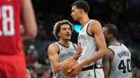 San Antonio Spurs forward Jeremy Sochan (10) talks to forward Victor Wembanyama (1) during the second half at Frost Bank Center.