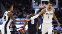 San Antonio Spurs forward Victor Wembanyama (1) receives congratulations from guard Devin Vassell (24) in the second half against the Detroit Pistons at Little Caesars Arena.