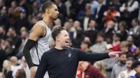San Antonio Spurs head coach Mitch Johnson gestures to a player as center Victor Wembanyama (1) walks by during a break in the action against the Toronto Raptors the second half at Scotiabank Arena.