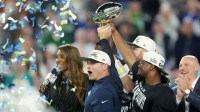 Seattle Seahawks head coach Mike MacDonald and Seattle Seahawks running back Kenneth Walker III (9) hoist the Vince Lombardi Trophy after defeating the New England Patriots in Super Bowl LX at Levi's Stadium.