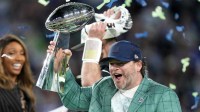 Seattle Seahawks general manager John Schneider celebrates with the Vince Lombardi trophy on the podium after defeating the New England Patriots in Super Bowl LX at Levi's Stadium.