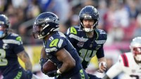 Seattle Seahawks quarterback Sam Darnold (14) hands off to running back Kenneth Walker III (9) during the first quarter against the New England Patriots in Super Bowl LX at Levi's Stadium.