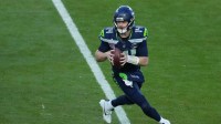 Seahawks quarterback Sam Darnold (14) drops back to pass