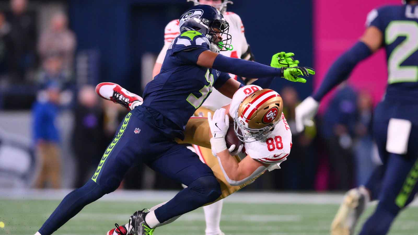 San Francisco 49ers tight end Jake Tonges (88) is tackled by Seattle Seahawks safety Nick Emmanwori (3) during the first half in an NFC Divisional Round game at Lumen Field.
