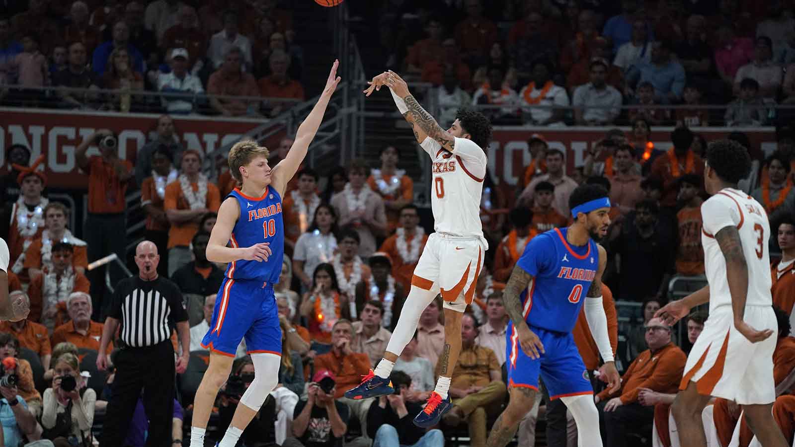 Texas Longhorns guard Jordan Pope (0) shoots a three point basket against Florida Gators forward Thomas Haugh (10) during the second half at Moody Center.
