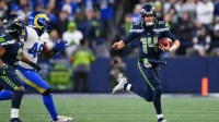 Seattle Seahawks quarterback Sam Darnold (14) runs against the Los Angeles Rams during the second half in the 2026 NFC Championship Game at Lumen Field.
