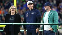 Seattle Seahawks chairman Jody Allen, head coach Mike MacDonald, and general manager John Schneider on the podium after defeating the New England Patriots in Super Bowl LX at Levi's Stadium.