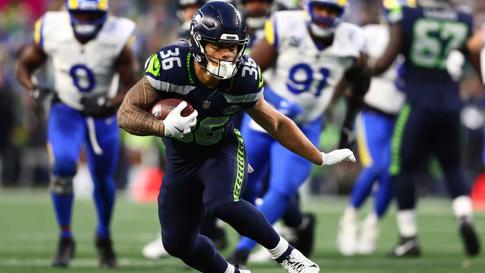 Seattle Seahawks running back George Holani (36) runs against the Los Angeles Rams during the first half in the 2026 NFC Championship Game at Lumen Field