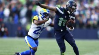Seattle Seahawks wide receiver Jaxon Smith-Njigba (11) runs against Los Angeles Rams cornerback Roger McCreary (25) during the first half in the 2026 NFC Championship Game at Lumen Field.