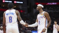 Oklahoma City Thunder guard Jalen Williams (8) and guard Shai Gilgeous-Alexander (2) react after a play during the third quarter against the Houston Rockets at Toyota Center.