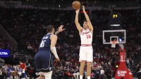 Houston Rockets guard Reed Sheppard (15) shoots the ball as Dallas Mavericks forward Caleb Martin (16) defends during the first quarter at Toyota Center.