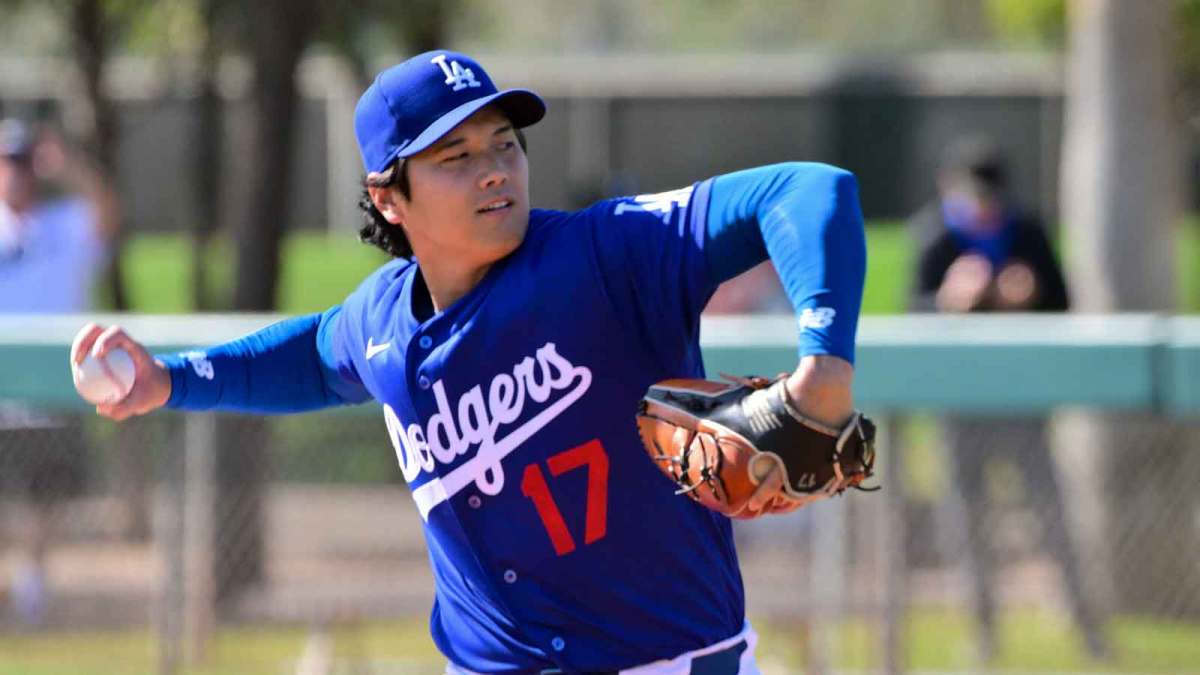 Los Angeles Dodgers two-way player Shohei Ohtani (17) throws looks on during a Spring Training workout at Camelback Ranch.