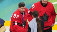 Sidney Crosby of Canada receives his silver medal in the men's ice hockey gold medal game during the Milano Cortina 2026 Olympic Winter Games at Milano Santagiulia Ice Hockey Arena.