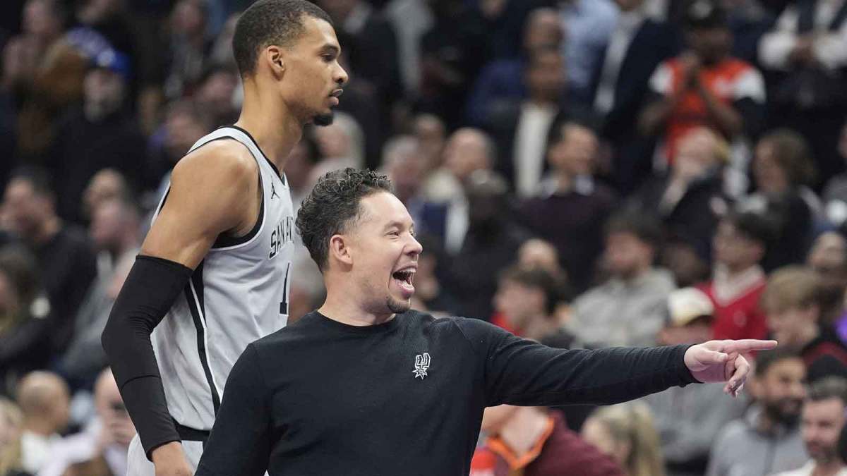 Spurs head coach Mitch Johnson gestures to a player as center Victor Wembanyama (1) walks by during a break in the action against the Toronto Raptors the second half at Scotiabank Arena