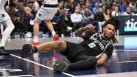 San Antonio Spurs guard Stephon Castle (5) looks up from the floor during the second half against the Dallas Mavericks at the American Airlines Center.