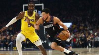 Phoenix Suns guard Devin Booker (1) against Los Angeles Lakers center Deandre Ayton (5) in the first half at Mortgage Matchup Center.