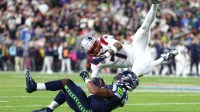 New England Patriots cornerback Carlton Davis III (7) tackles Seattle Seahawks running back Kenneth Walker III (9) during the fourth quarter in Super Bowl LX at Levi's Stadium.