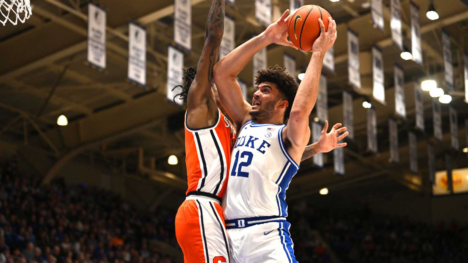 Duke Blue Devils forward Cameron Boozer (12) brings the ball to the basket against Syracuse Orange forward Donnie Freeman (1) during the during the second half at Cameron Indoor Stadium.