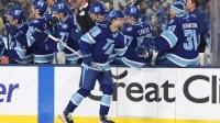 Tampa Bay Lightning left wing Brandon Hagel (38) reacts with teammates after scoring a goal against the Boston Bruins during the first period in the 2026 Stadium Series ice hockey game at Raymond James Stadium