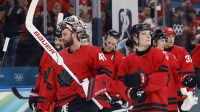 Players of Canada celebrate after the match against Switzerland in men's ice hockey group A play during the Milano Cortina 2026 Olympic Winter Games at Milano Santagiulia Ice Hockey Arena.