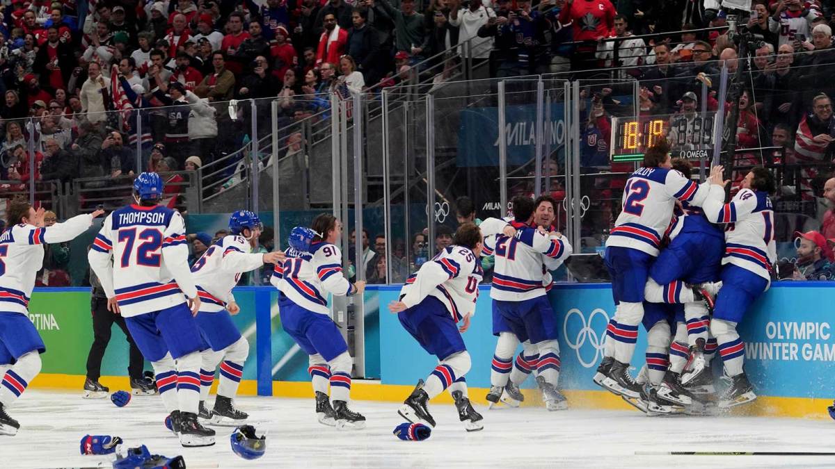 Jack Hughes (86) of the United States is congratulated by teammates after scoring the winning goal against Canada in the men's ice hockey gold medal game during the Milano Cortina 2026 Olympic Winter Games at Milano Santagiulia Ice Hockey Arena.